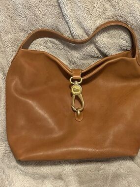Dooney and Bourke logo lock Florentine Natural